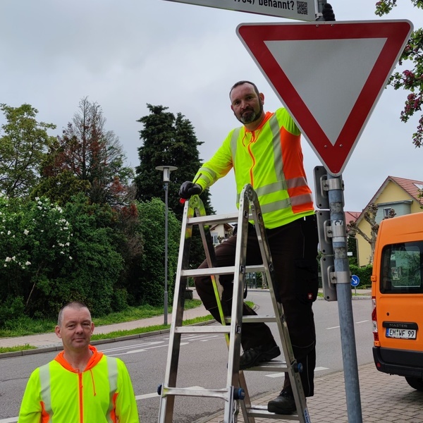 Christian Bhler und Matthias Nbling vom Verbandsbauhof montieren das Zusatzschild zur Hindenburgstrae.